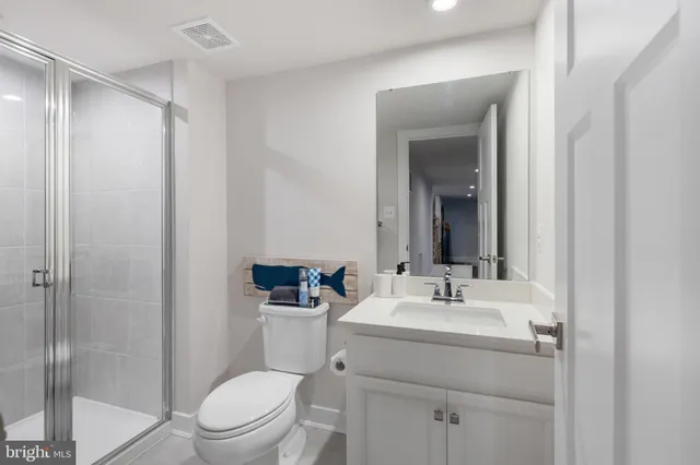 a bathroom with a toilet a sink and a mirror