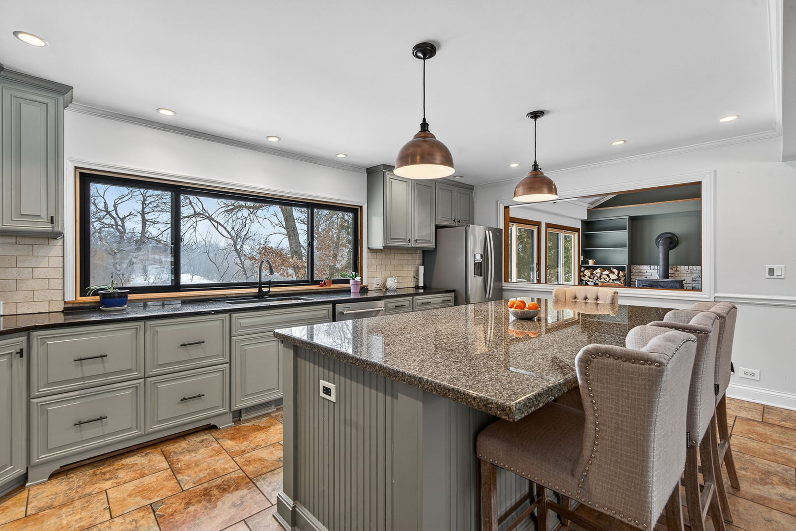 1275 Country Club Road Lake Zurich, IL 60047 - Photo 11 of 49 a kitchen with granite countertop a stove a sink a dining table and chairs with wooden floor