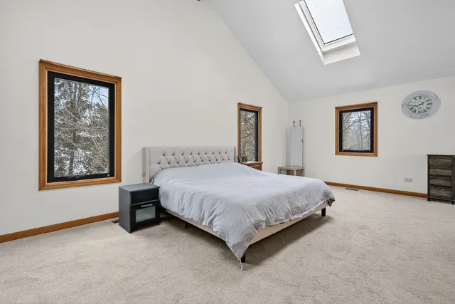 a bedroom with a bed lamp and window