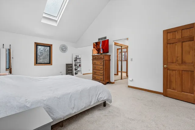 a bedroom with a bed and dresser