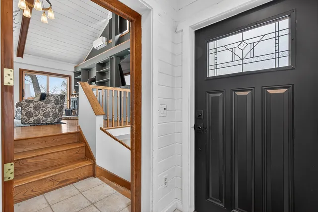 a view of entryway with wooden floor and livingroom view
