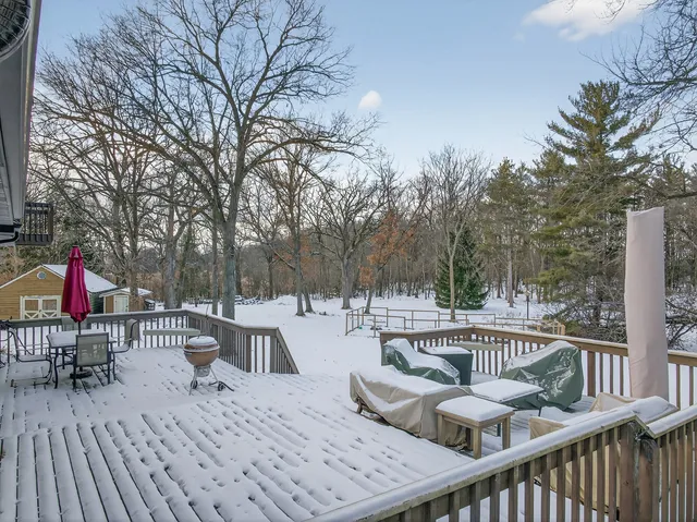 a view of a roof deck with furniture
