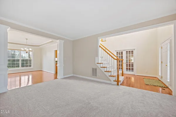 a view of an empty room with a window and fireplace