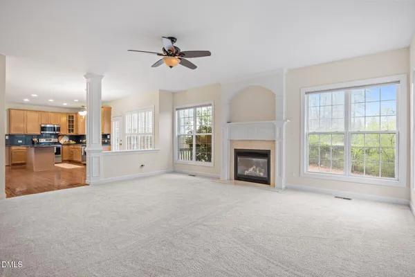 a view of a livingroom with a fireplace and a large window