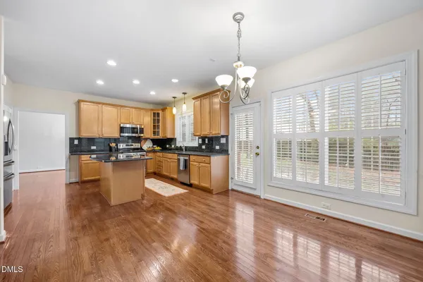 a kitchen with granite countertop cabinets stainless steel appliances and a sink