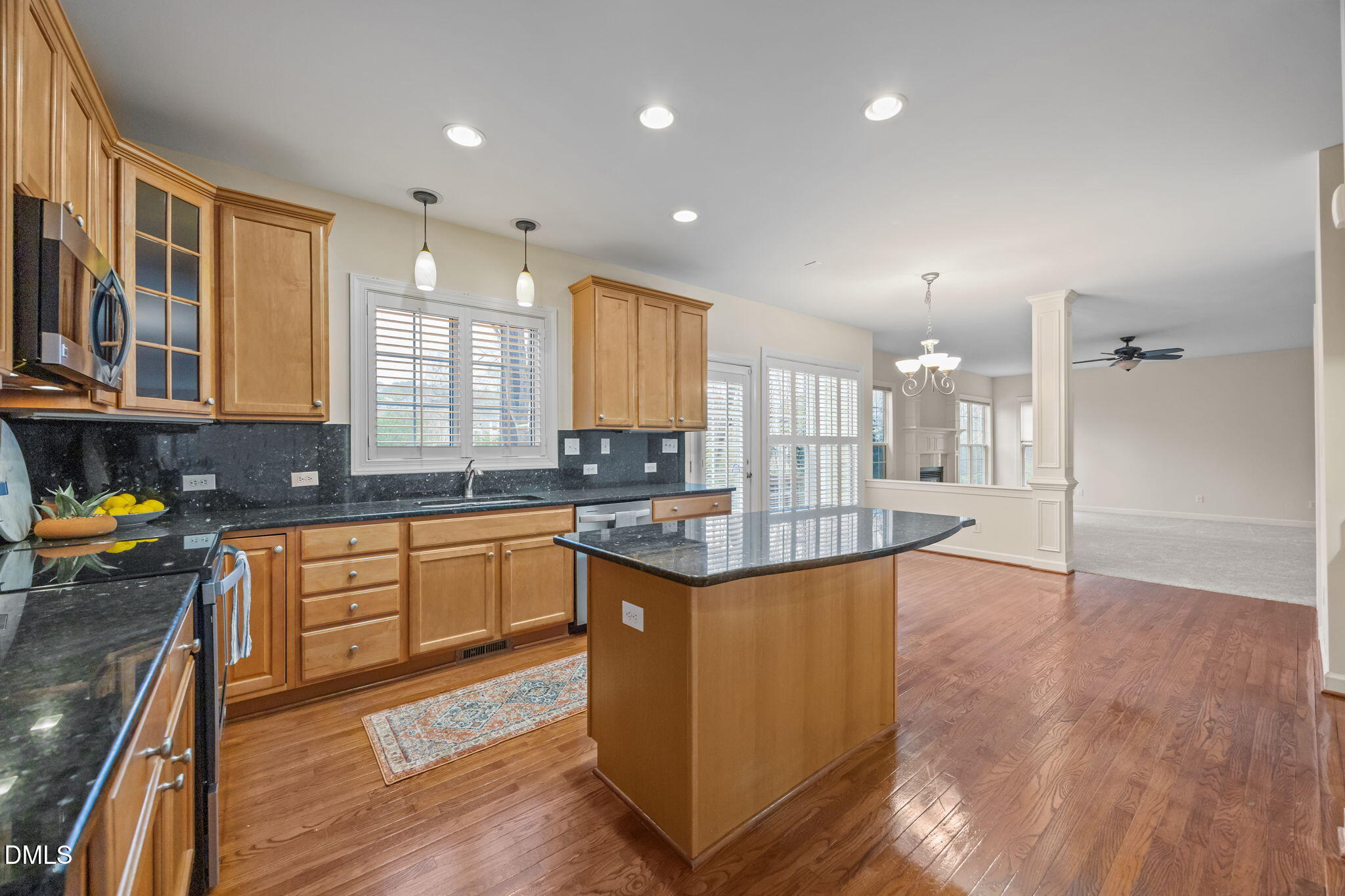 7 Bobcat Court Durham, NC 27713 - Photo 21 of 64 a kitchen with stainless steel appliances granite countertop a stove a sink dishwasher and a refrigerator with wooden floor