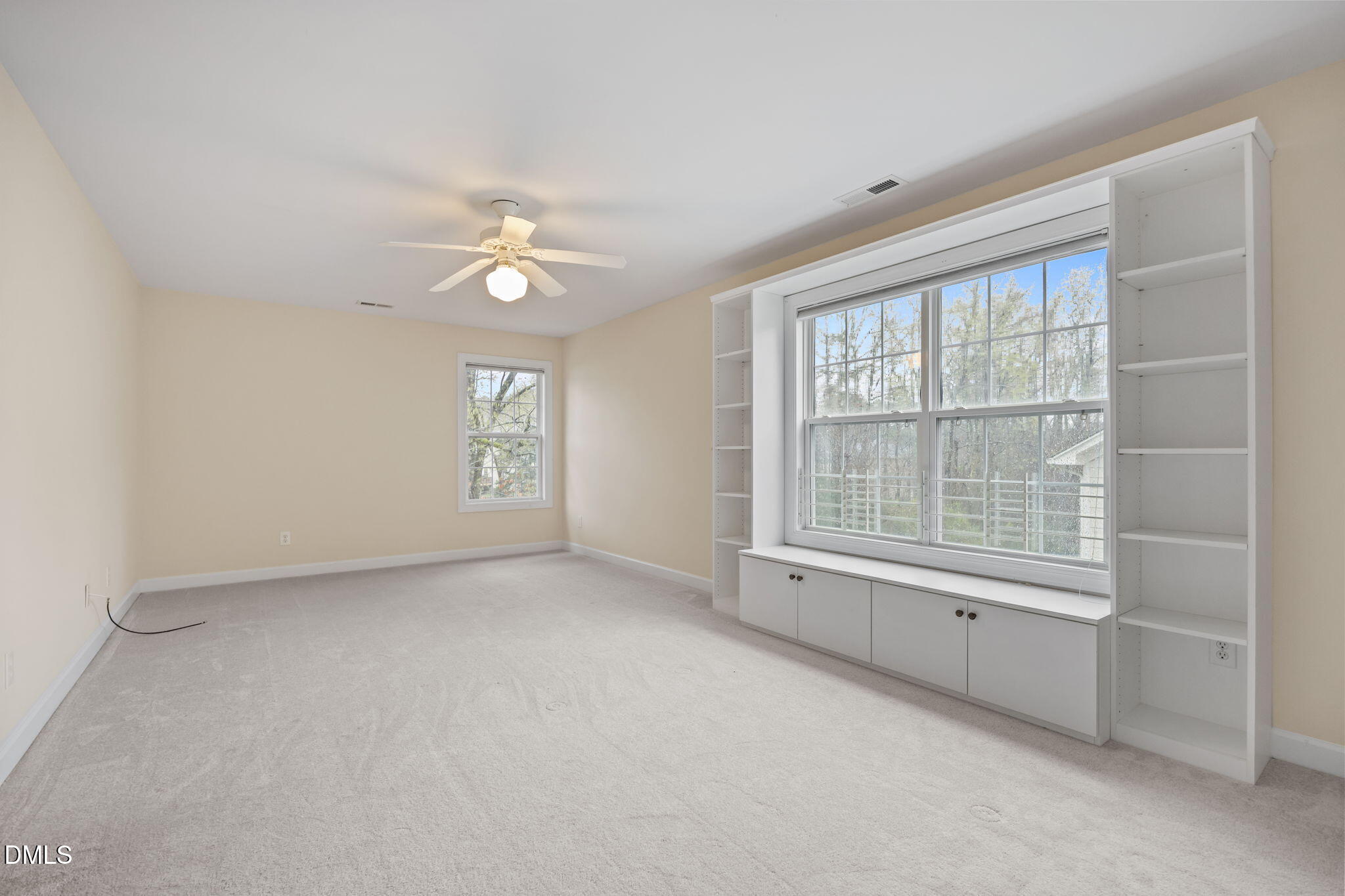 7 Bobcat Court Durham, NC 27713 - Photo 29 of 64 an empty room with chandelier fan and windows