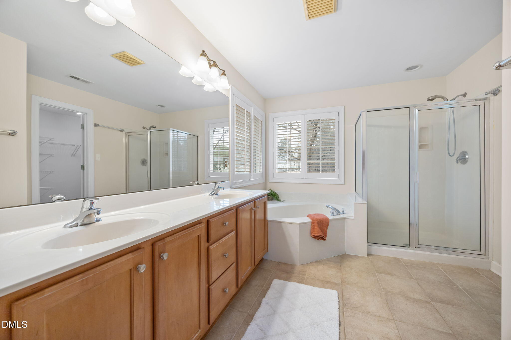 7 Bobcat Court Durham, NC 27713 - Photo 38 of 64 a bathroom with a double vanity sink toilet mirror and bathtub