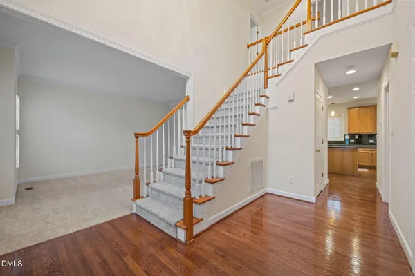 a view of entryway with wooden floor and stairs