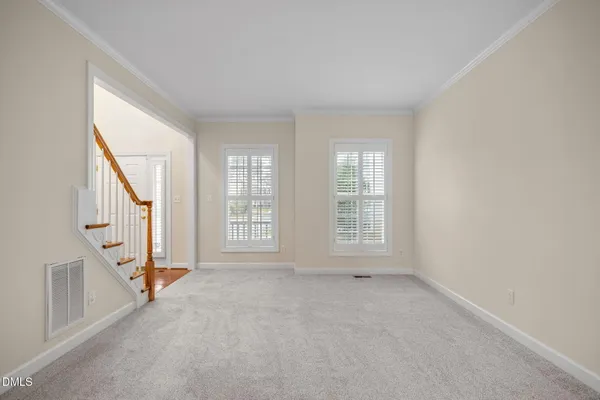 a view of an empty room with a fireplace and a window
