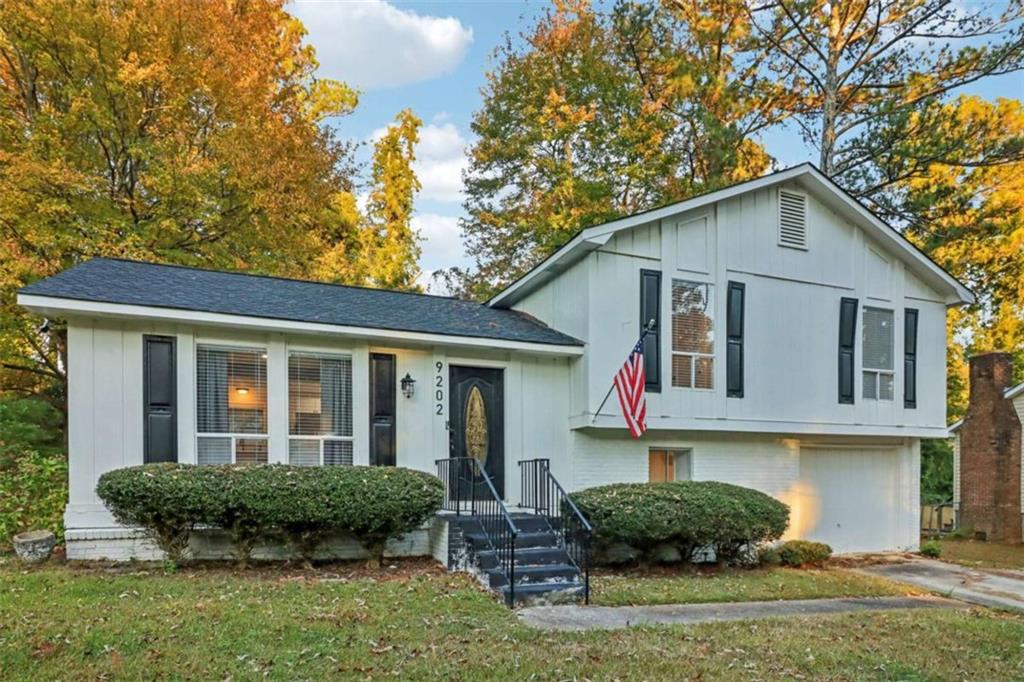 9202 Settlers Grove Road Northeast Covington, GA 30014 - Photo 1 of 45 a view of a house with a yard and plants