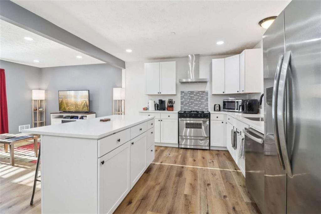 9202 Settlers Grove Road Northeast Covington, GA 30014 - Photo 15 of 45 a kitchen with white cabinets appliances and a sink