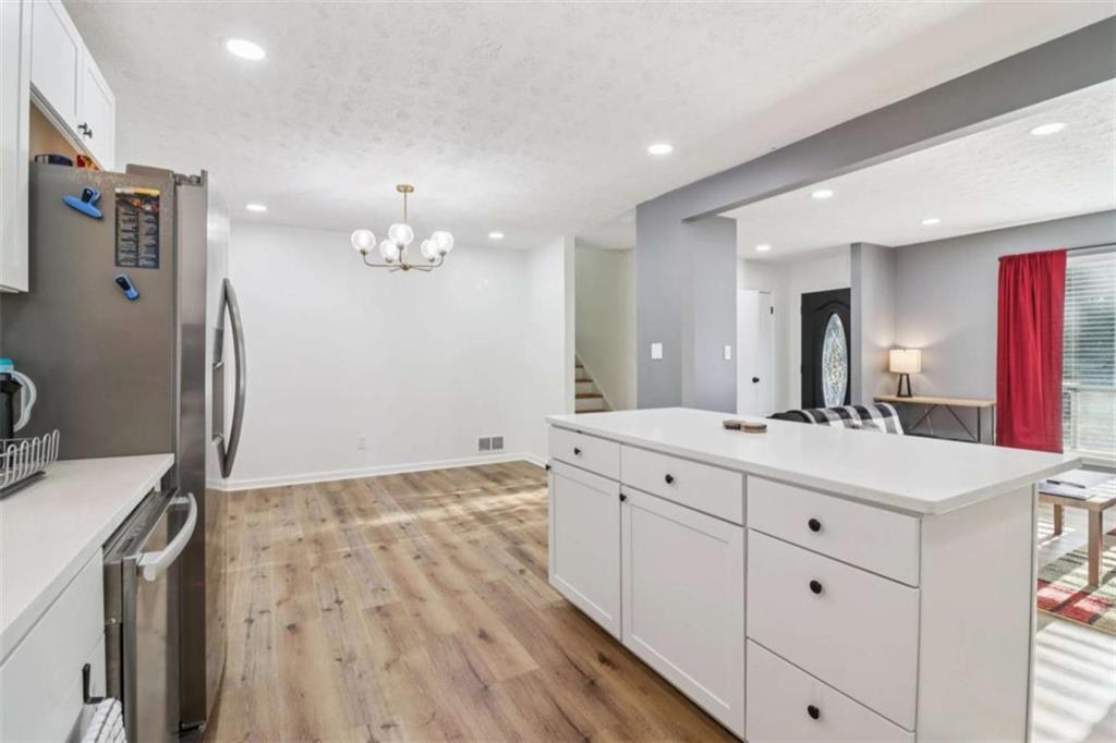 9202 Settlers Grove Road Northeast Covington, GA 30014 - Photo 16 of 45 a spacious bathroom with a granite countertop sink a toilet a mirror and vanity