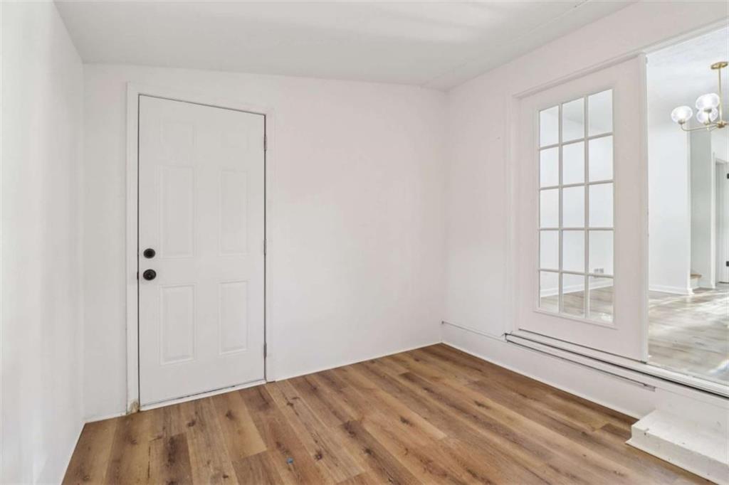 9202 Settlers Grove Road Northeast Covington, GA 30014 - Photo 20 of 45 an empty room with wooden floor closet and windows