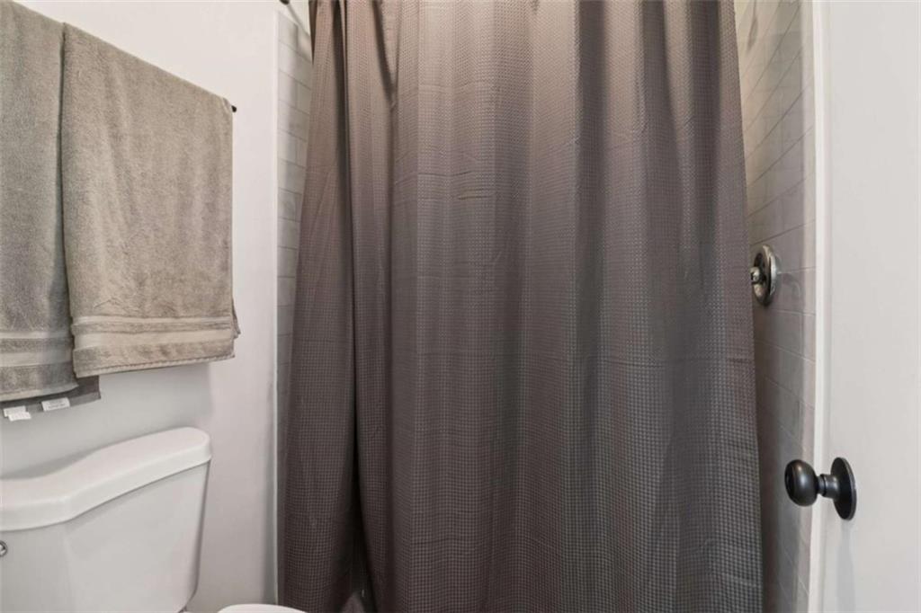 9202 Settlers Grove Road Northeast Covington, GA 30014 - Photo 22 of 45 a bathroom with a shower curtain