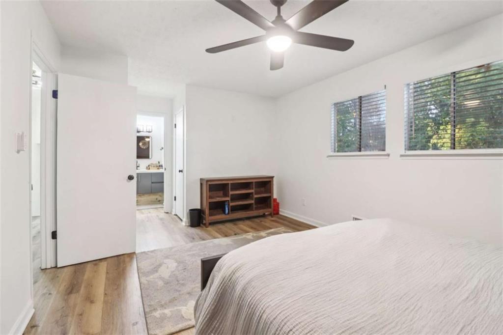 9202 Settlers Grove Road Northeast Covington, GA 30014 - Photo 26 of 45 a spacious bedroom with a bed and ceiling fan