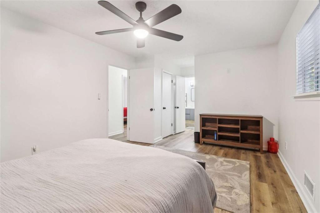 9202 Settlers Grove Road Northeast Covington, GA 30014 - Photo 27 of 45 a bedroom with a bed and a chandelier