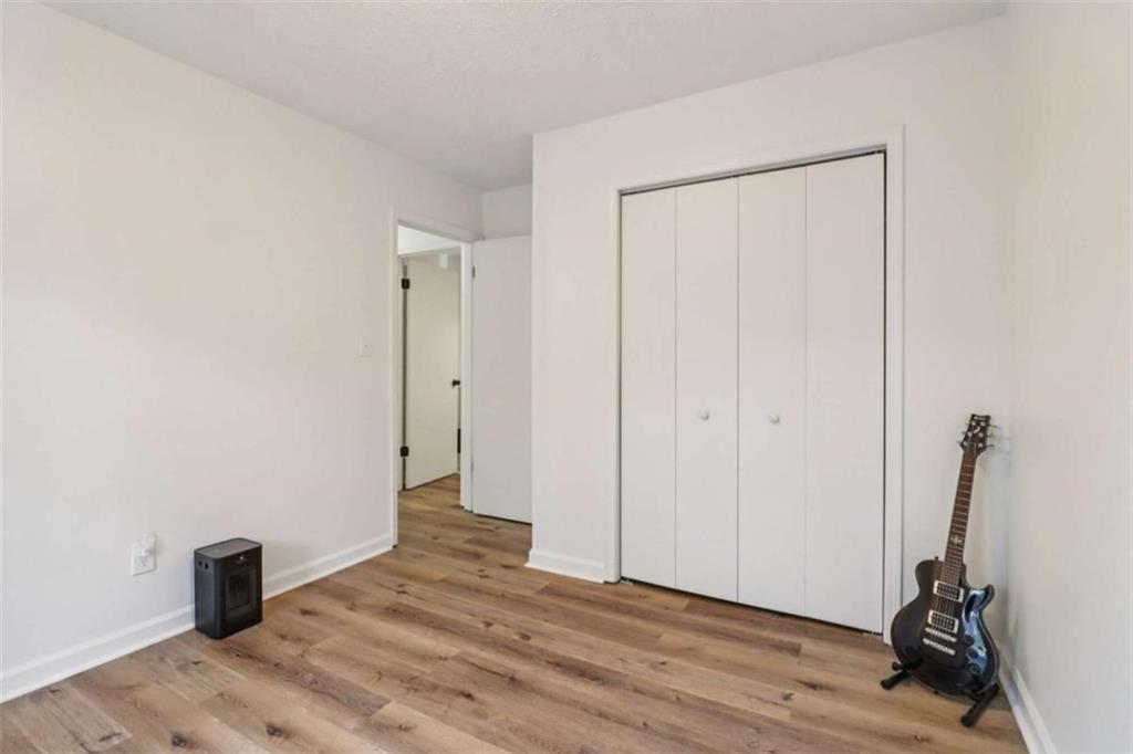 9202 Settlers Grove Road Northeast Covington, GA 30014 - Photo 30 of 45 a view of a room with wooden floor and a ceiling fan