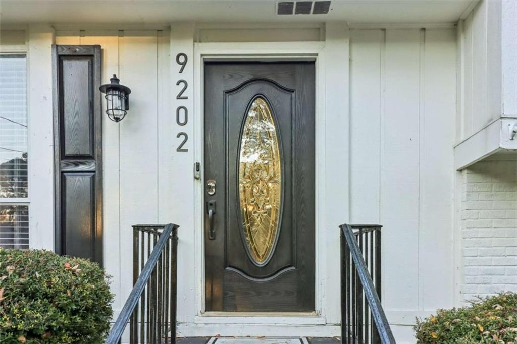 9202 Settlers Grove Road Northeast Covington, GA 30014 - Photo 3 of 45 a front view of a house with garden