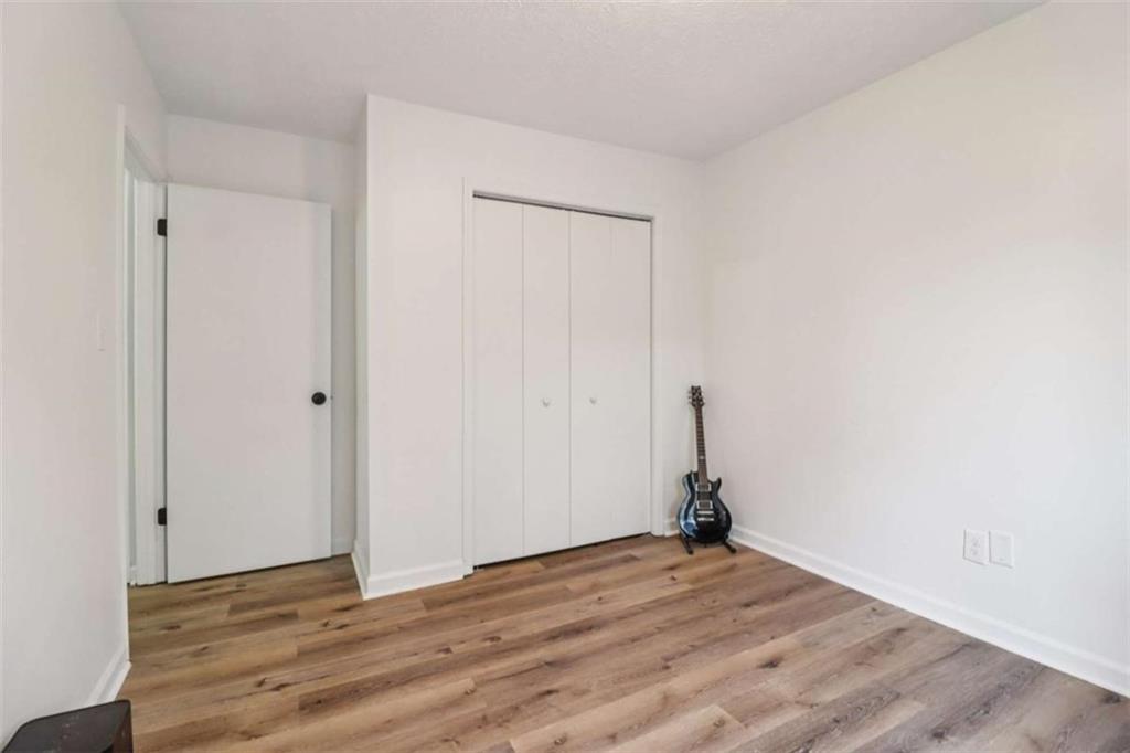 9202 Settlers Grove Road Northeast Covington, GA 30014 - Photo 31 of 45 a view of empty room with wooden floor