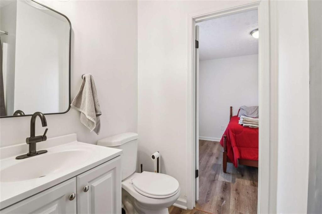 9202 Settlers Grove Road Northeast Covington, GA 30014 - Photo 32 of 45 a bathroom with a sink vanity mirror and toilet