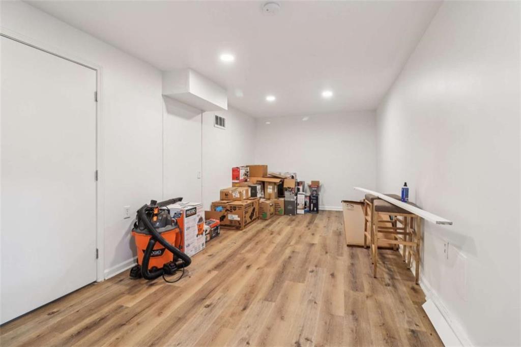 9202 Settlers Grove Road Northeast Covington, GA 30014 - Photo 37 of 45 a view of a room with wooden floor and air hockey table