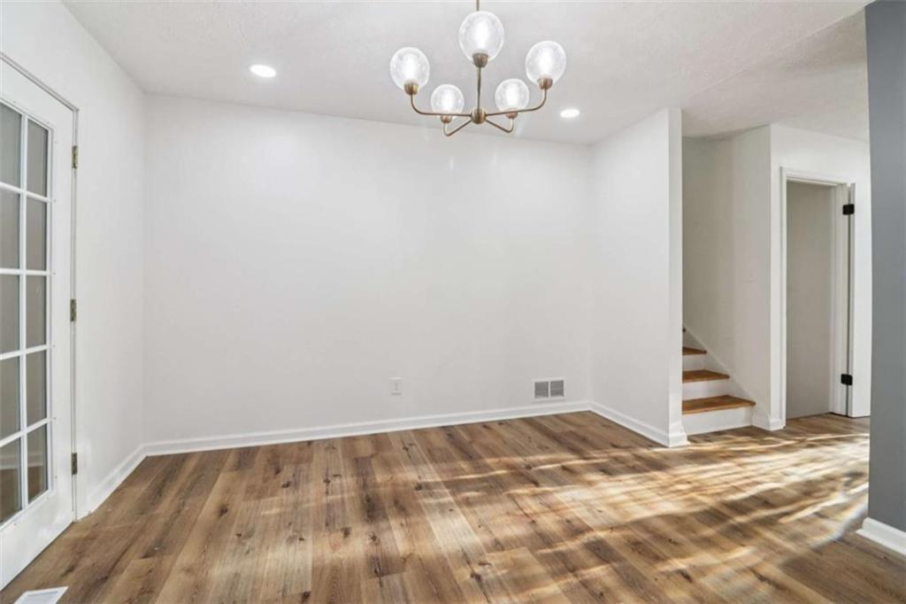 9202 Settlers Grove Road Northeast Covington, GA 30014 - Photo 10 of 45 wooden floor in an empty room with a window