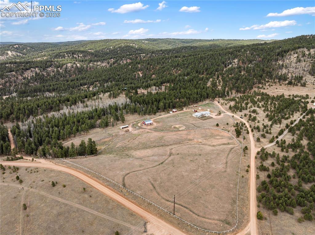 585 Mills Ranch Road Woodland Park, CO 80863 - Photo 12 of 46 Aerial view of sparsely populated area with a forest