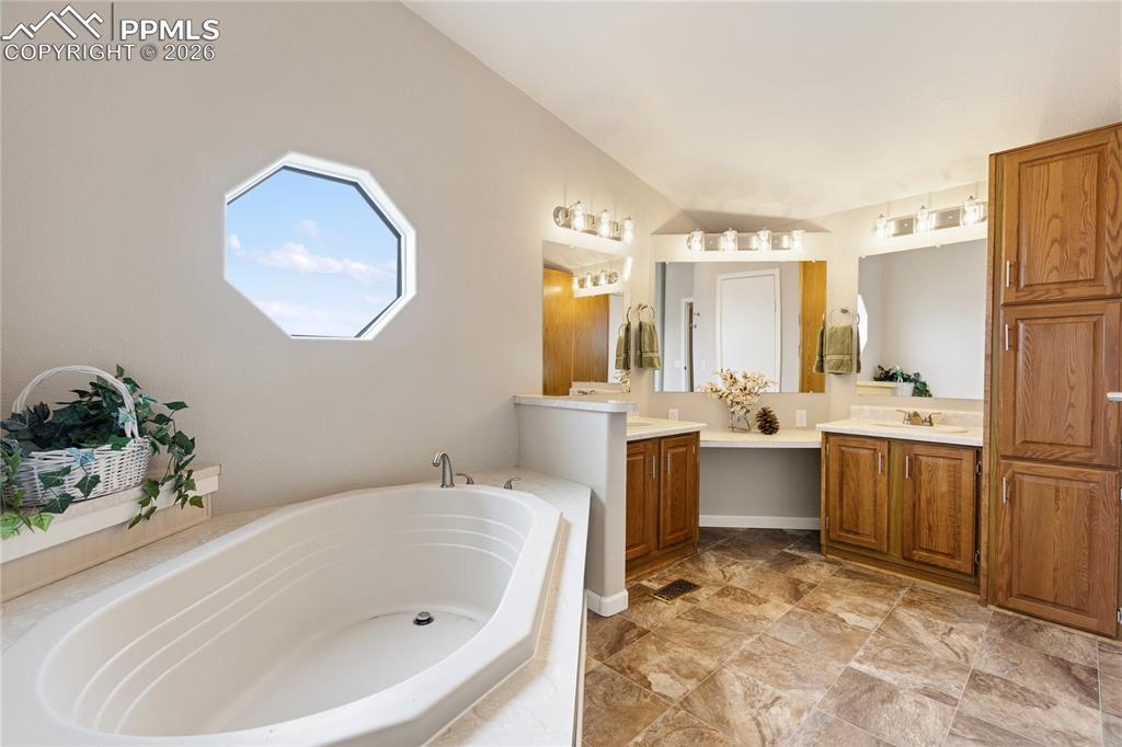 585 Mills Ranch Road Woodland Park, CO 80863 - Photo 38 of 46 Bathroom featuring two vanities and a bath