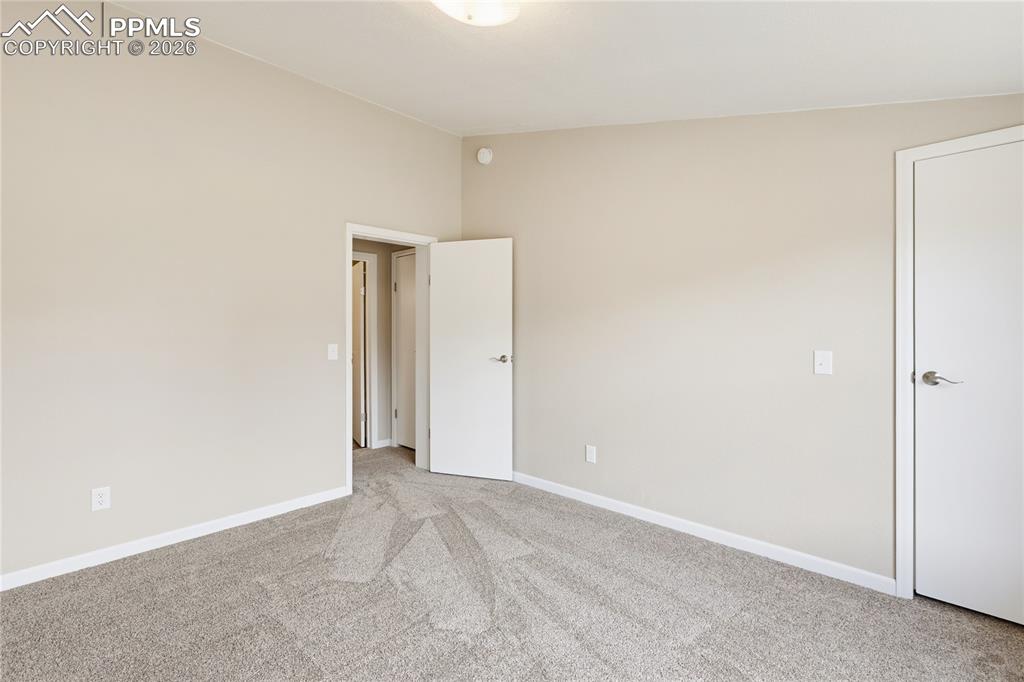 585 Mills Ranch Road Woodland Park, CO 80863 - Photo 45 of 46 3rd Bdrm light colored carpet and baseboards