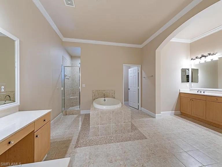 3590 Lansing Loop, Unit 201 Estero, FL 33928 - Photo 6 of 18 a spacious bathroom with a double vanity sink a large mirror and a shower
