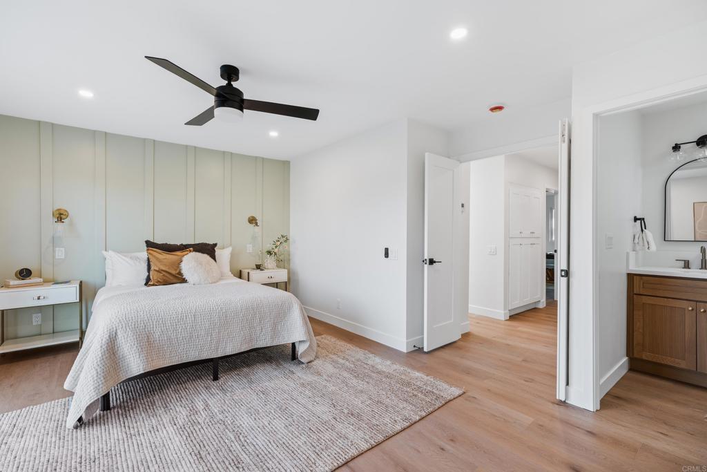 1608 Towell Lane Escondido, CA 92029 - Photo 21 of 35 a bedroom with a bed and a chandelier