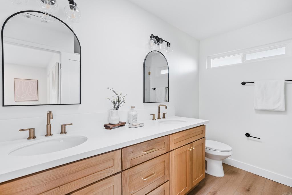 1608 Towell Lane Escondido, CA 92029 - Photo 24 of 35 a bathroom with a double vanity sink and a mirror