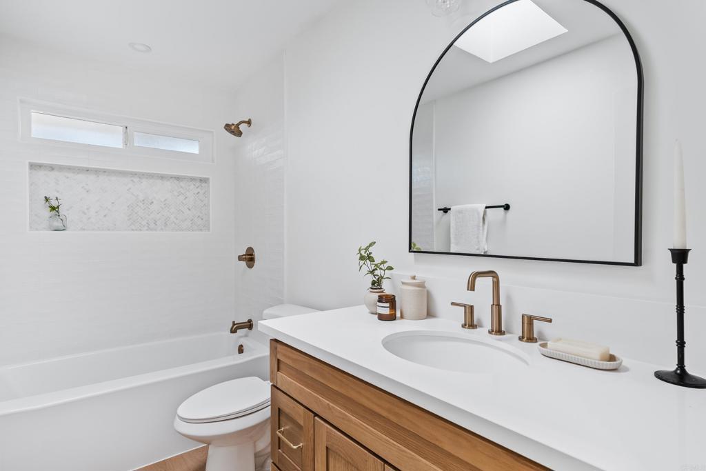 1608 Towell Lane Escondido, CA 92029 - Photo 27 of 35 a bathroom with a sink toilet vanity mirror and bathtub