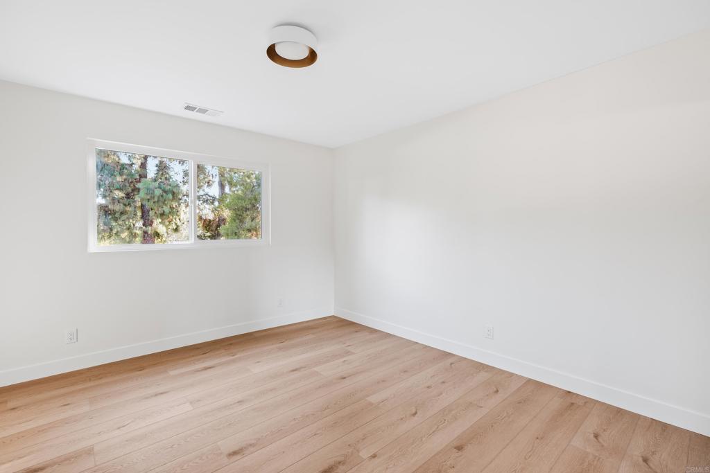 1608 Towell Lane Escondido, CA 92029 - Photo 29 of 35 an empty room with wooden floor and windows