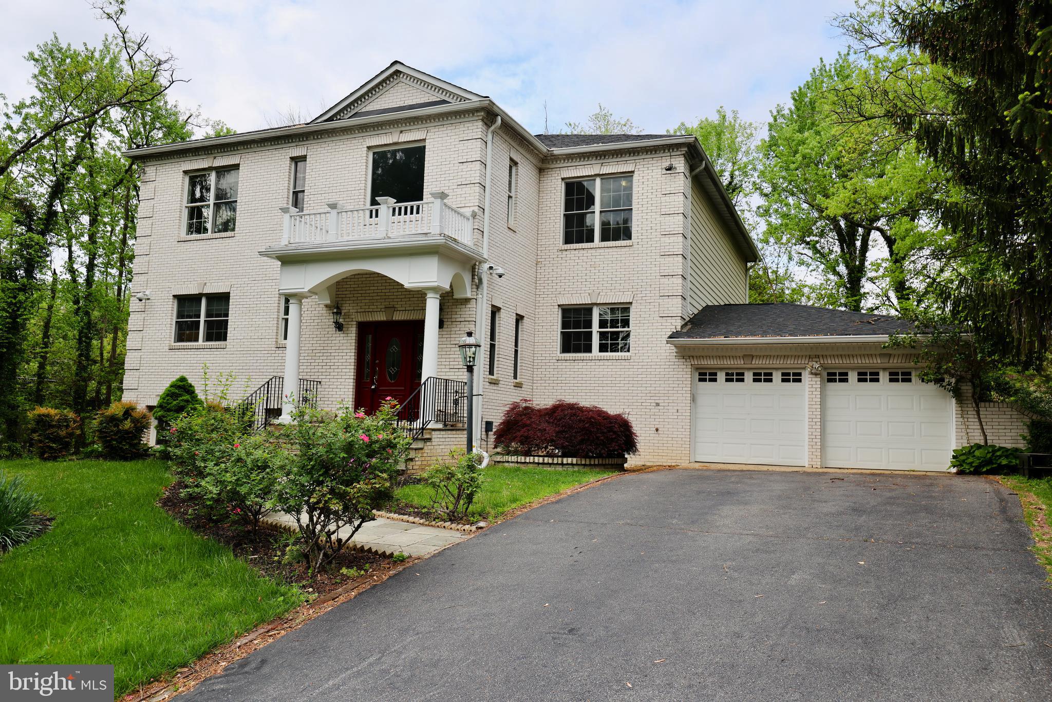 1310 Forestwood Drive McLean, VA 22101 - Photo 1 of 55 a front view of a house with a yard and garage