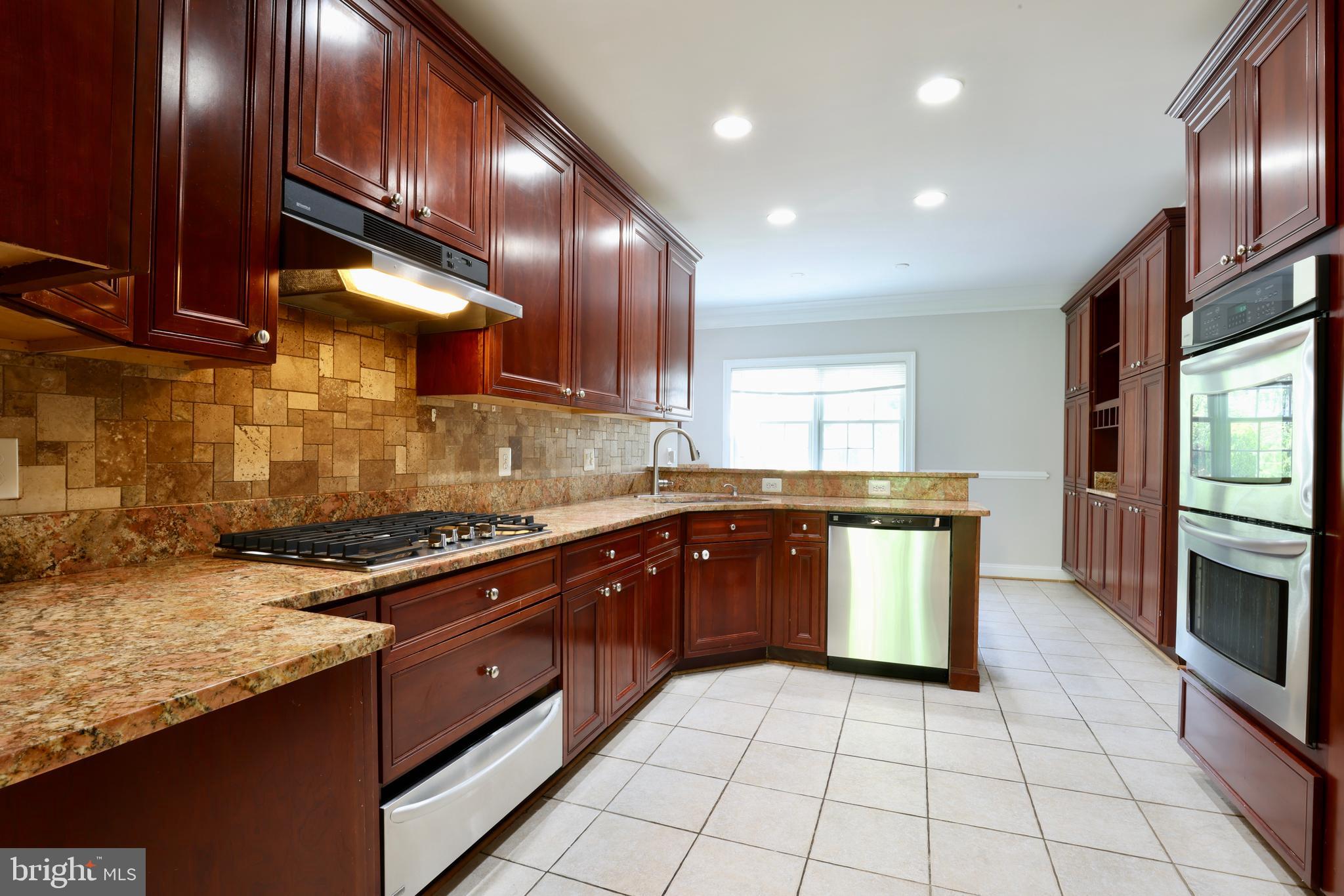 1310 Forestwood Drive McLean, VA 22101 - Photo 18 of 55 a kitchen with granite countertop a stove a sink and a microwave