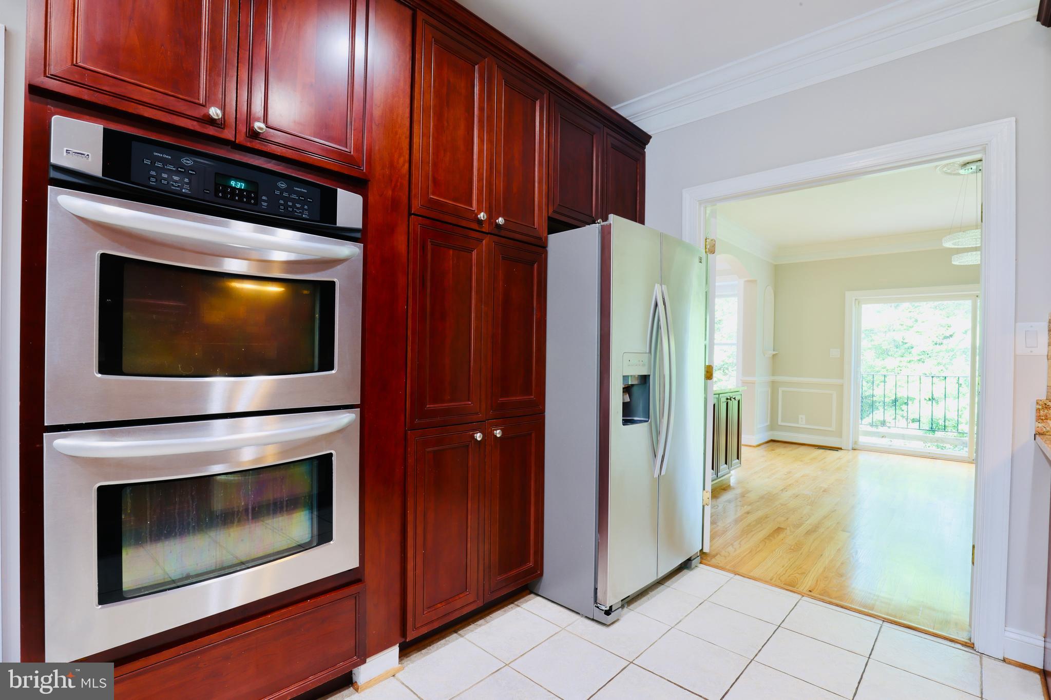 1310 Forestwood Drive McLean, VA 22101 - Photo 20 of 55 a living room with stainless steel appliances wooden floor and fireplace
