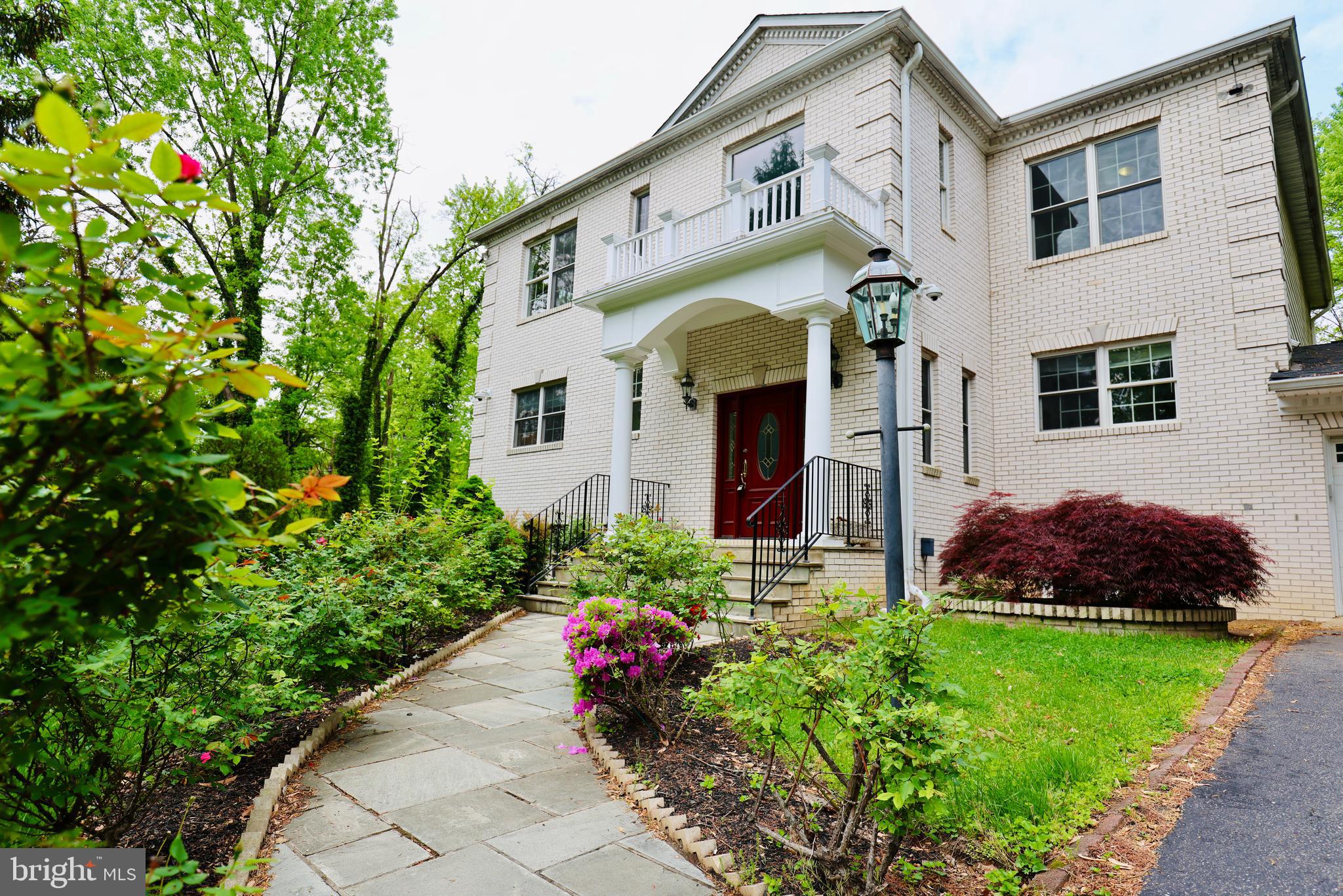 1310 Forestwood Drive McLean, VA 22101 - Photo 2 of 55 a front view of a house with a garden and plants