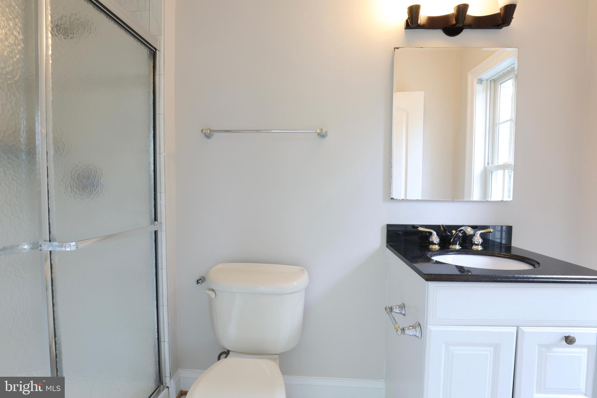 1310 Forestwood Drive McLean, VA 22101 - Photo 45 of 55 a bathroom with a toilet sink and mirror