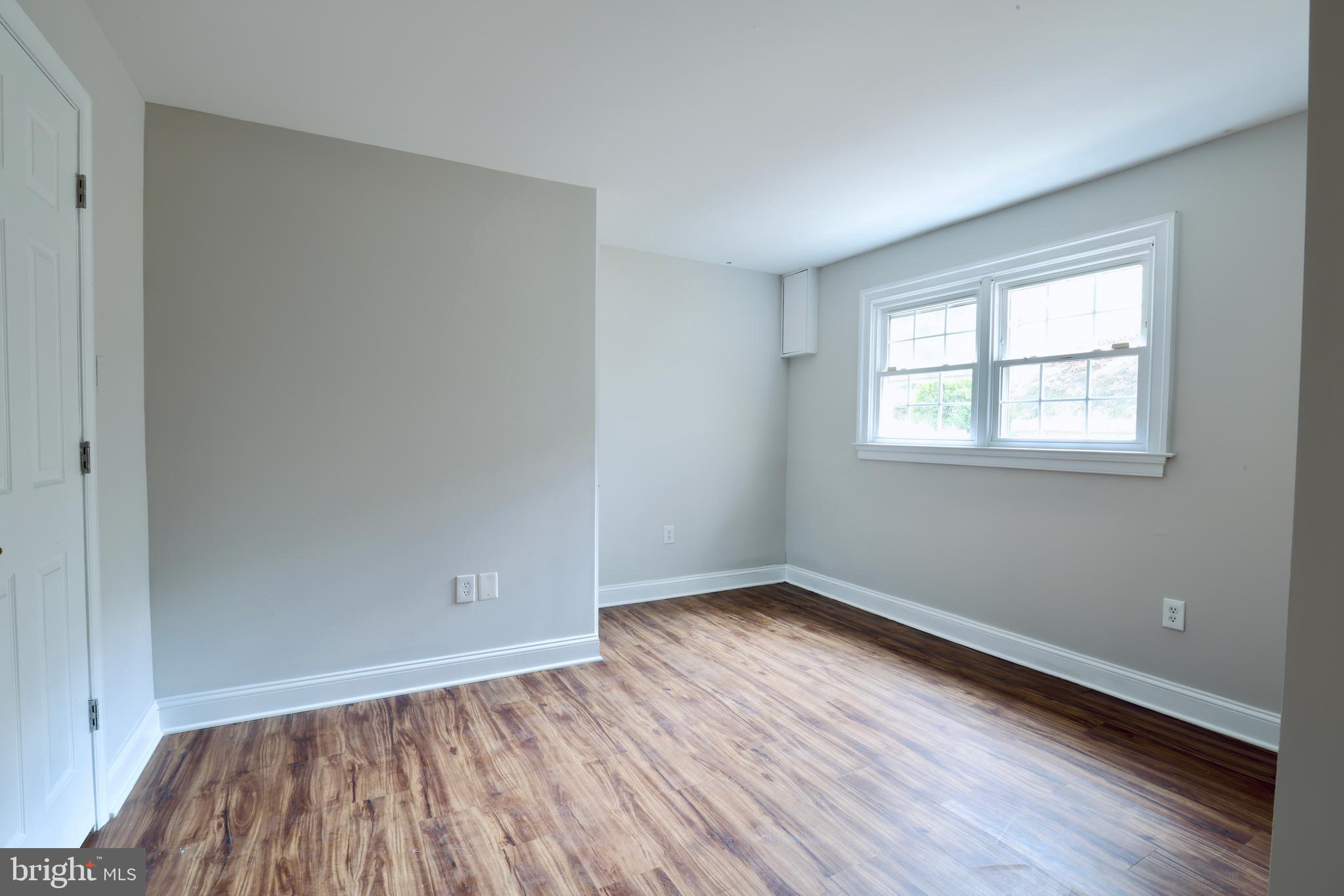 1310 Forestwood Drive McLean, VA 22101 - Photo 46 of 55 an empty room with wooden floor and windows