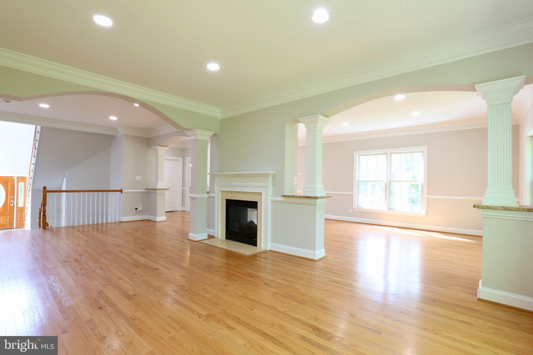 1310 Forestwood Drive McLean, VA 22101 - Photo 7 of 55 a view of empty room with wooden floor and fireplace