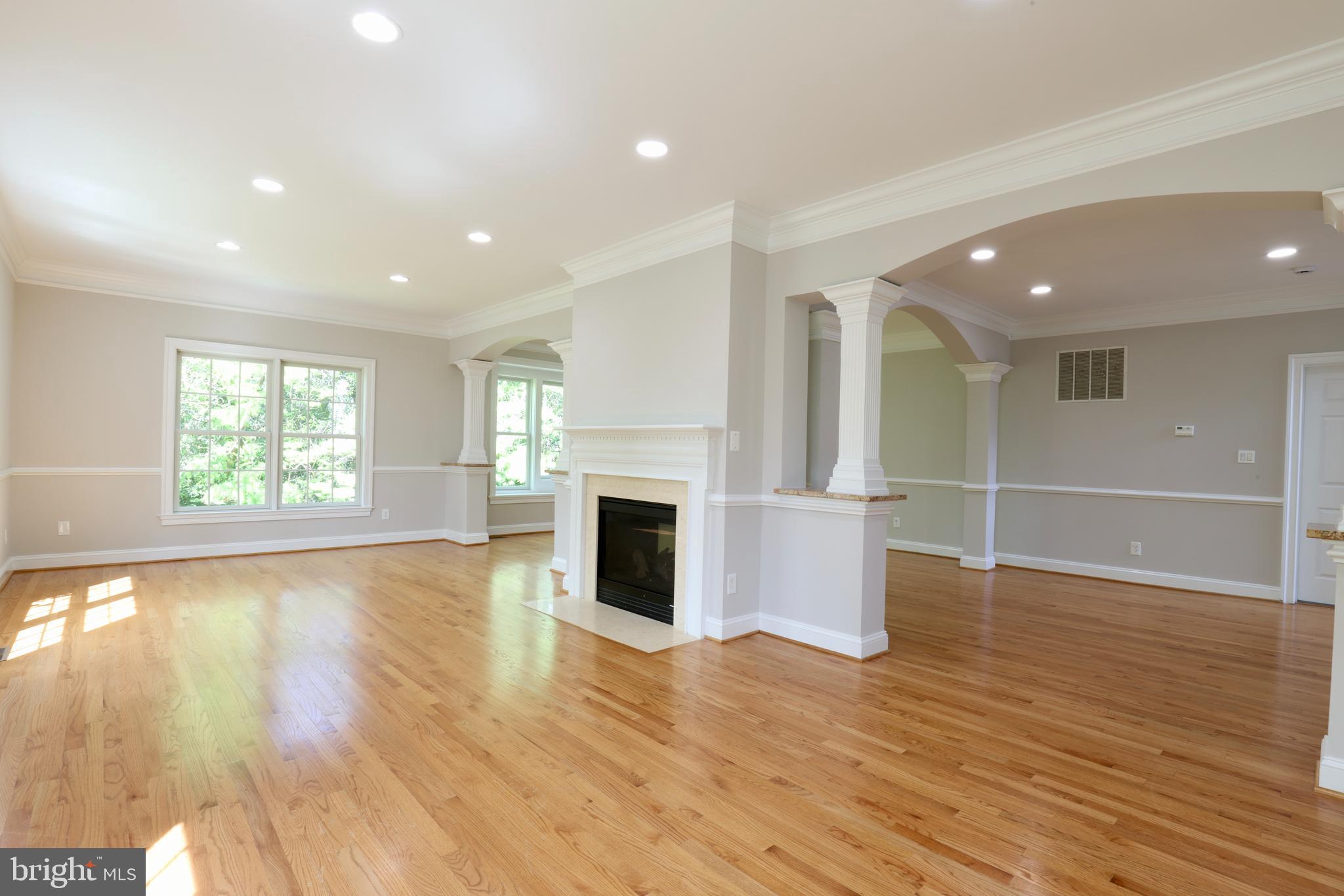 1310 Forestwood Drive McLean, VA 22101 - Photo 10 of 55 an empty room with wooden floor fireplace and windows