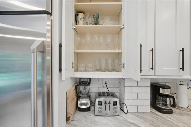 a large bedroom with a bed and a chandelier