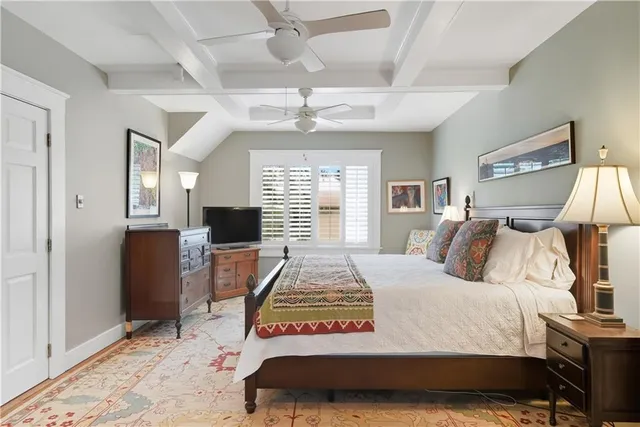 a bedroom with bed and a large window