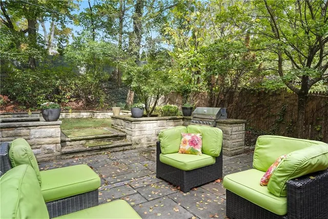 a view of a house with swimming pool and sitting area