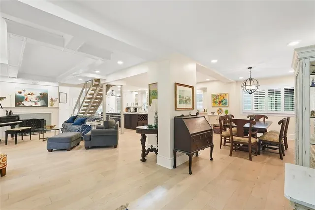 a living room with furniture a fireplace and a large window