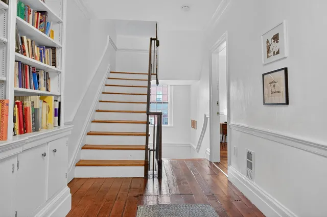 a bedroom with bed and wooden floor