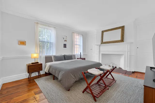 a bedroom with a bed and a night stand