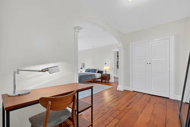a view of a chair and table in backyard of the house